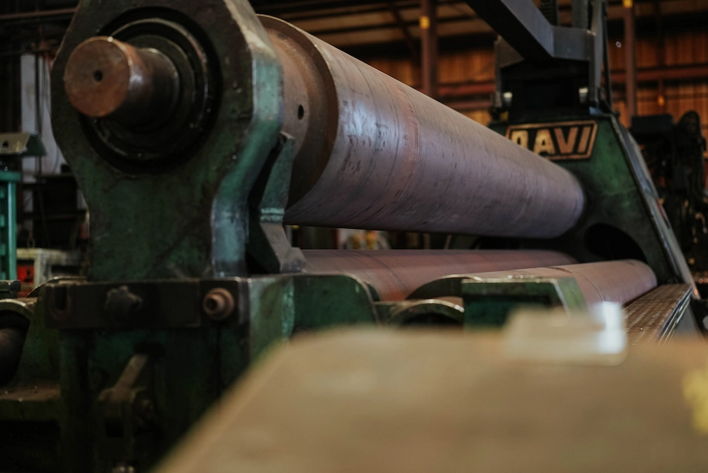 Steel sheet being shaped through a rolling machine