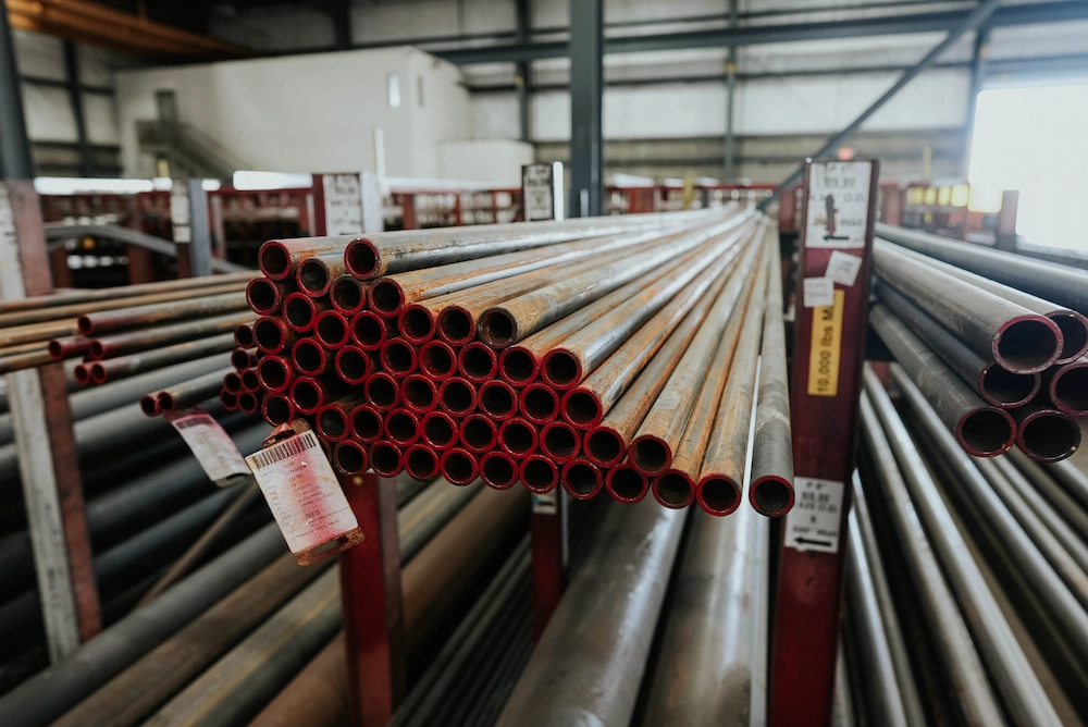 Stacked steel pipes in warehouse